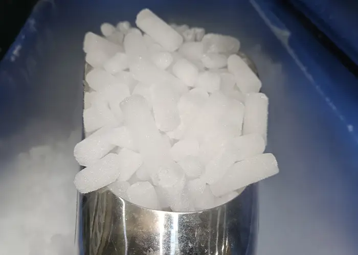 Stainless steel scoop filled with 16mm dry ice pellets